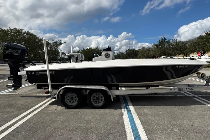The Image of 2010 Paramount Sportfisherman 21' boat on trailer, parked in a lot under cloudy sky. - 0