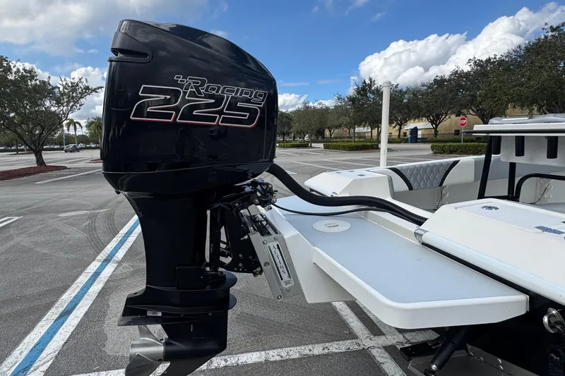 Slide: The Image of 2010 Paramount Sportfisherman 21' with Racing 225 outboard motor in parking lot. - 14
