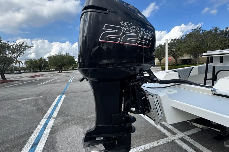 Slide: The Image of Outboard motor on a 2010 Paramount Sportfisherman 21' boat in a parking lot. - 15