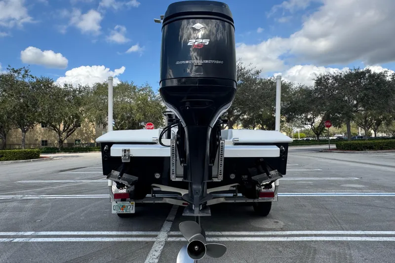 Slide: The Image of 2010 Paramount Sportfisherman 21' boat with powerful outboard motor in parking lot. - 16