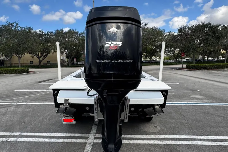 Slide: The Image of 2010 Paramount Sportfisherman 21' boat with powerful 225 HP outboard motor in parking lot. - 17