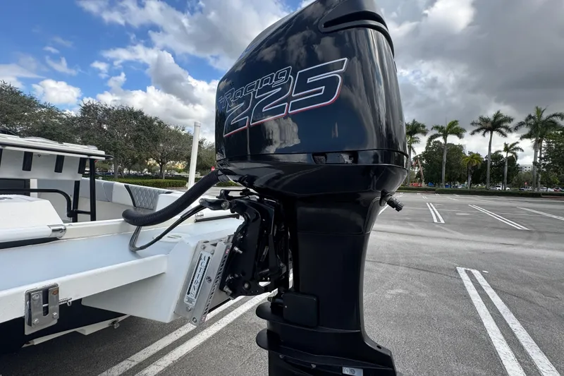 Slide: The Image of 2010 Paramount Sportfisherman 21' with powerful outboard motor in parking lot. - 18