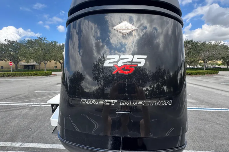 Slide: The Image of Outboard motor with "225 XS Direct Injection" label on a Paramount Sportfisherman boat. - 21
