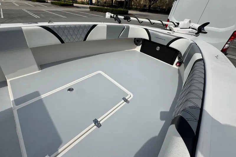 Slide: The Image of 2010 Paramount Sportfisherman 21' boat interior with cushioned seating and storage compartments. - 29