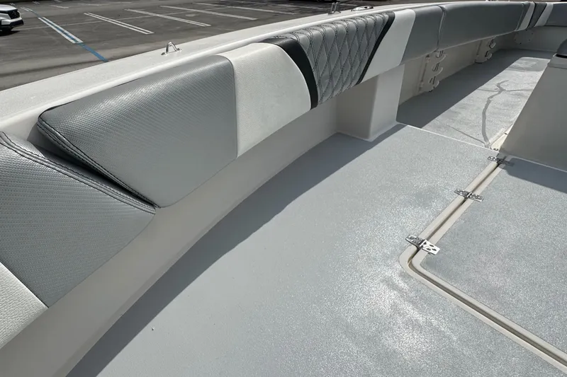 Slide: The Image of 2010 Paramount Sportfisherman 21' boat interior with cushioned seating and storage compartments. - 31