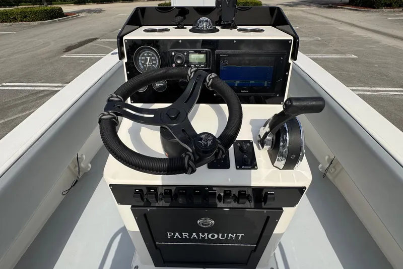 Slide: The Image of Control panel of a 2010 Paramount Sportfisherman 21' boat with steering wheel and gauges. - 39