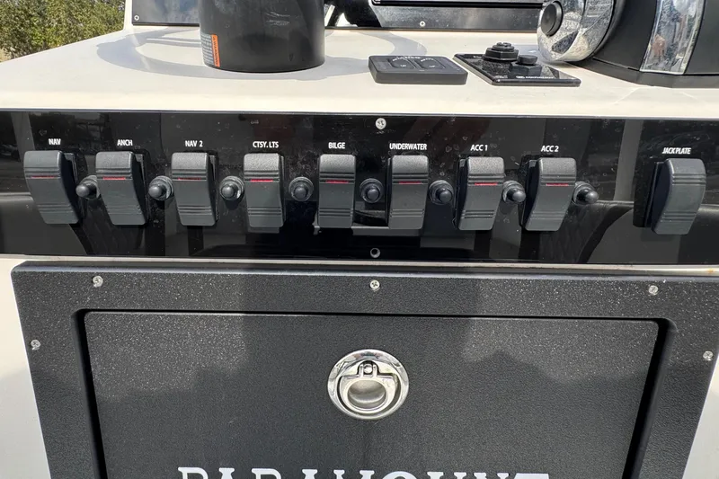 Slide: The Image of Control panel of a 2010 Paramount Sportfisherman 21' boat with labeled switches. - 43