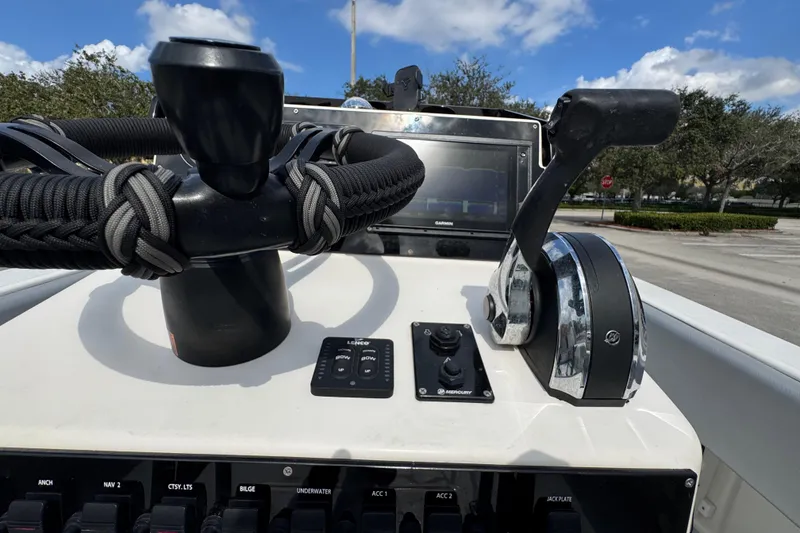 Slide: The Image of Control panel of a 2010 Paramount Sportfisherman 21' boat with steering and throttle. - 46