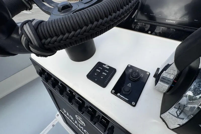 Slide: The Image of Control panel of a 2010 Paramount Sportfisherman 21' boat with Garmin display and Mercury controls. - 49