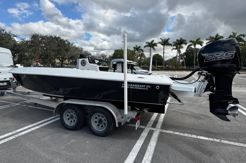 Slide: The Image of 2010 Paramount Sportfisherman 21' boat on trailer, parked in lot under cloudy sky. - 5