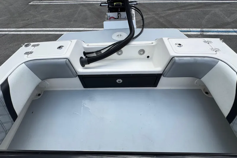 Slide: The Image of 2010 Paramount Sportfisherman 21' boat interior with cushioned seating and storage compartments. - 50