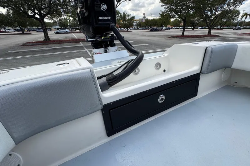 Slide: The Image of 2010 Paramount Sportfisherman 21' boat interior with Mercury engine in parking lot. - 51