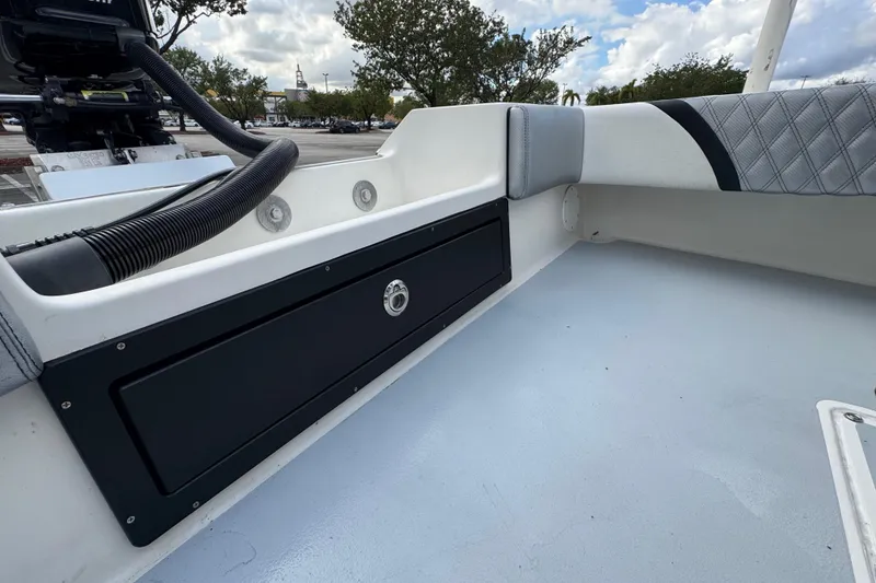 Slide: The Image of Interior view of a 2010 Paramount Sportfisherman 21' boat, featuring storage compartment. - 52