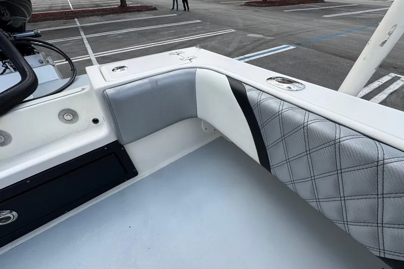 Slide: The Image of 2010 Paramount Sportfisherman 21' boat interior with cushioned seating in a parking lot. - 54