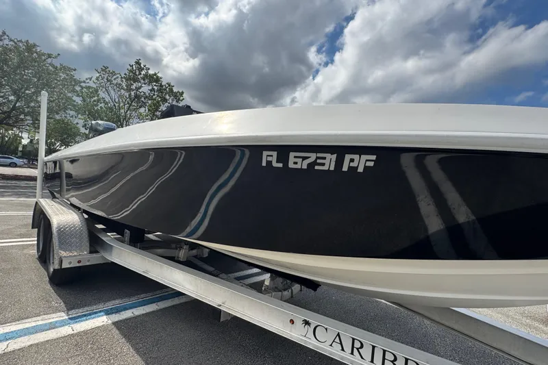 Slide: The Image of 2010 Paramount Sportfisherman 21' boat on trailer under cloudy sky. - 6