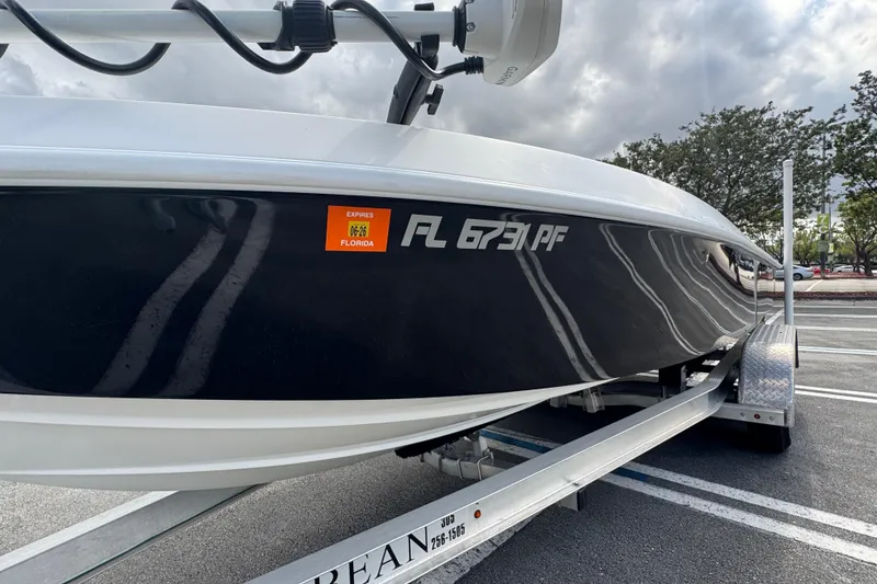 Slide: The Image of 2010 Paramount Sportfisherman 21' boat on trailer, Florida registration visible. - 7