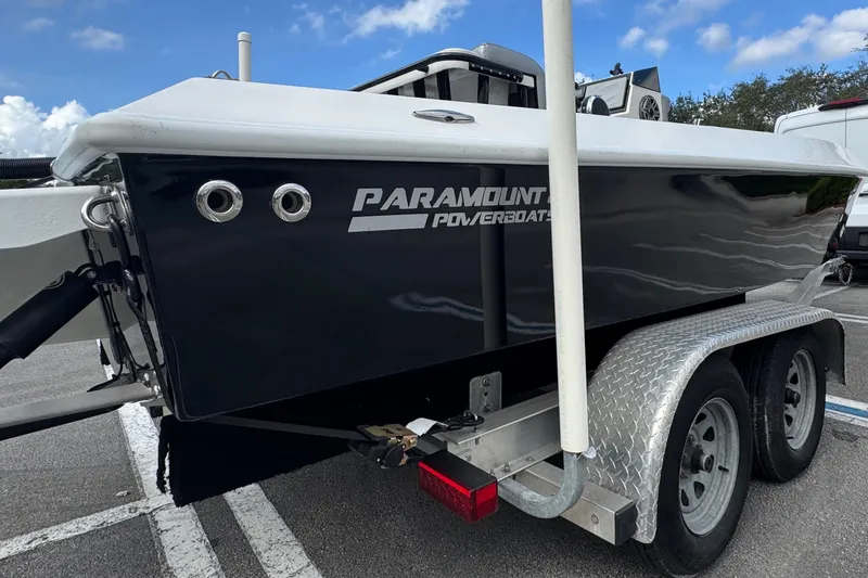 Slide: The Image of 2010 Paramount Sportfisherman 21' boat on trailer, parked outdoors under blue sky. - 8