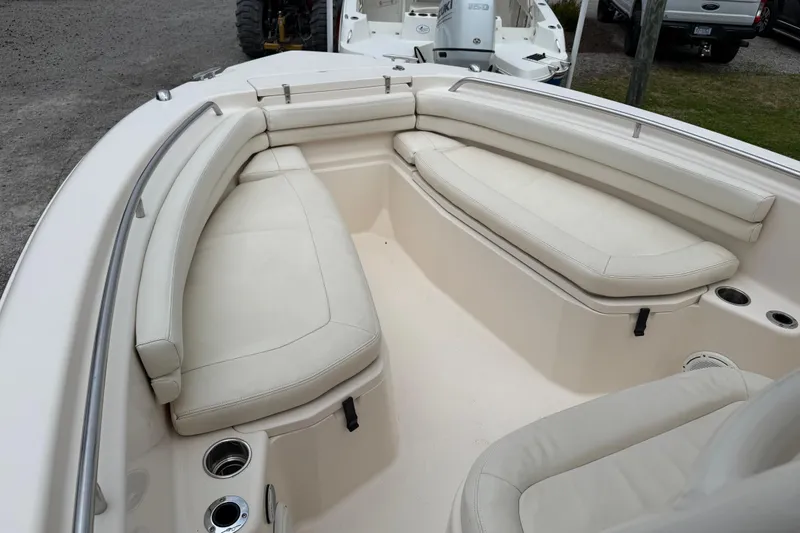 Slide: The Image of 2015 Grady-White Fisherman 257 boat interior with cushioned seating and cup holders. - 19