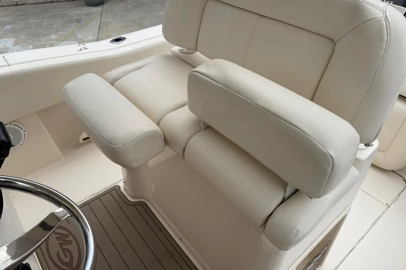 Slide: The Image of 2015 Grady-White Fisherman 257 boat seat with beige upholstery and armrests. - 24