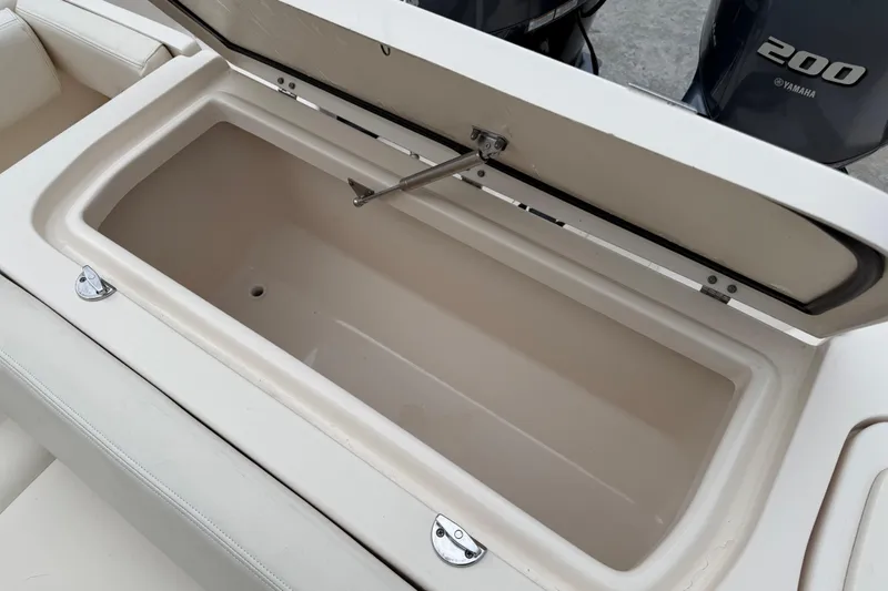 Slide: The Image of Open storage compartment on 2015 Grady-White Fisherman 257 boat, with Yamaha 200 engine visible. - 30