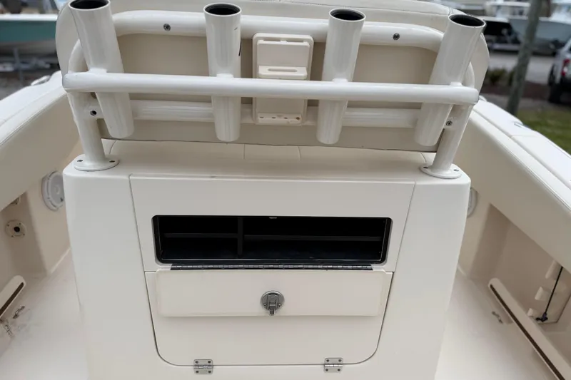 Slide: The Image of 2015 Grady-White Fisherman 257 boat interior with rod holders and storage compartment. - 31