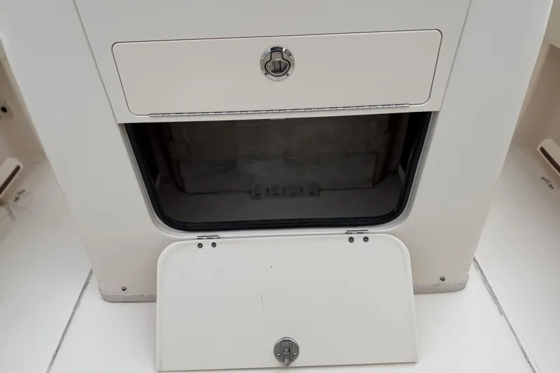 Slide: The Image of Storage compartment on a 2015 Grady-White Fisherman 257 boat, open and empty. - 32