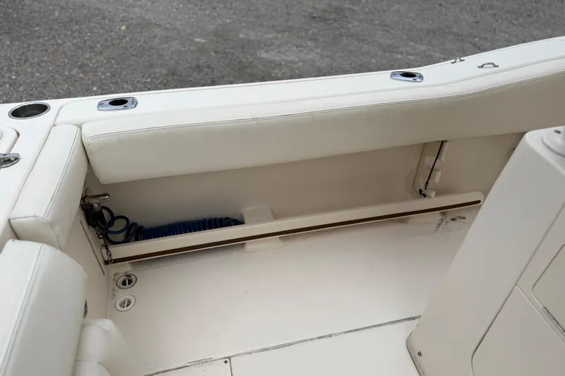 Slide: The Image of 2015 Grady-White Fisherman 257 boat interior with white seating and storage area. - 35