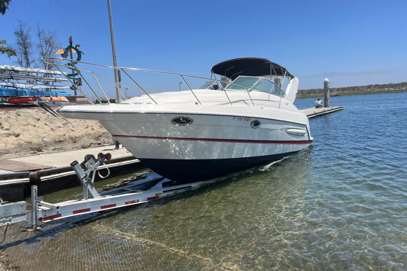 The Image of 2004 Maxum 2900 SE boat docked at marina during sunset. - 0