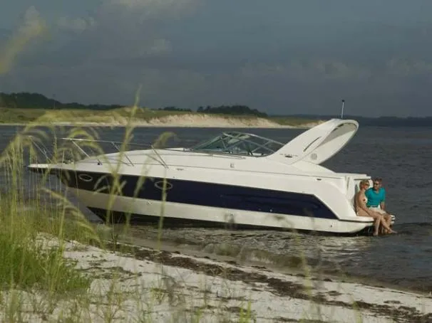 Slide: The Image of 2004 Maxum 2900 SE boat interior with gray carpet and white seating. - 12