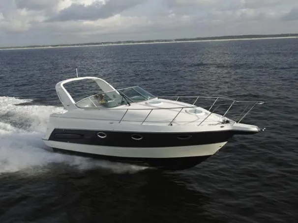 Slide: The Image of 2004 Maxum 2900 SE boat bathroom with sink, toilet, and porthole window. - 13