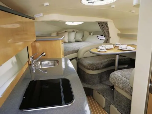 Slide: The Image of 2004 Maxum 2900 SE interior storage compartments with porthole window. - 14