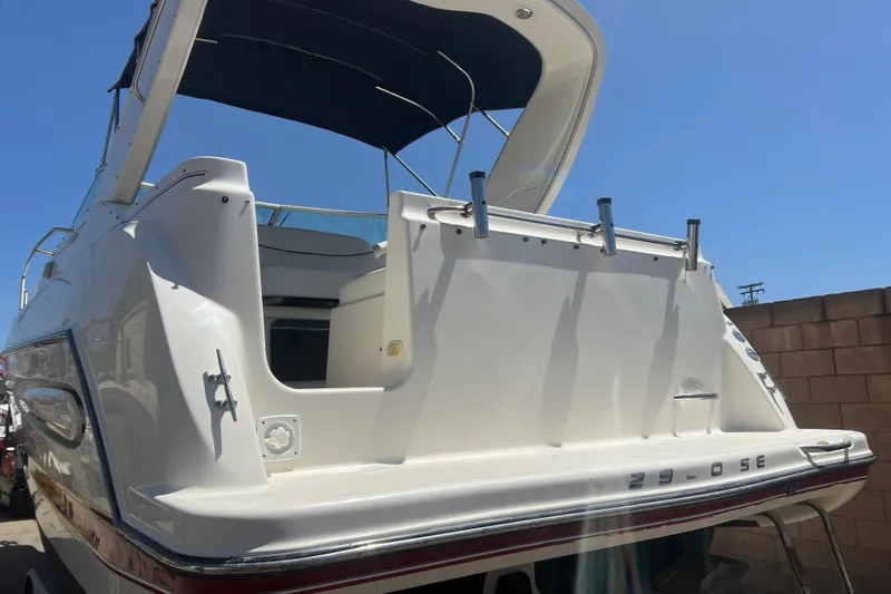 Slide: The Image of 2004 Maxum 2900 SE boat on trailer at a sunny dockside location. - 3