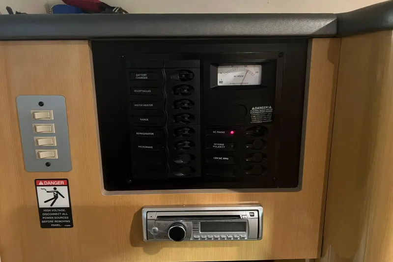 Slide: The Image of 2004 Maxum 2900 SE boat interior with white seating and storage area. - 9