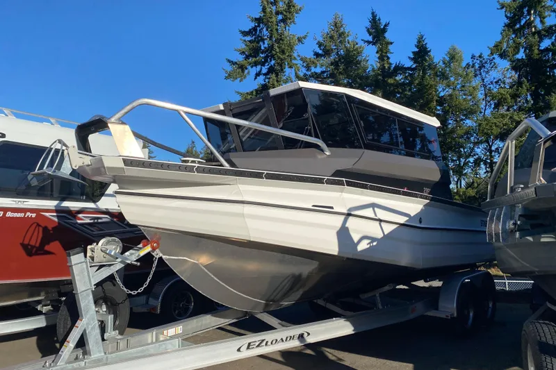 The Image of 2026 Stabicraft 2350 ULTRACAB WT SPORTFISH boat on trailer, surrounded by trees. - 0