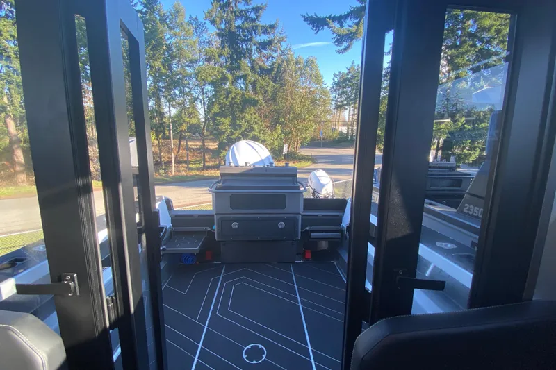 Slide: The Image of 2026 Stabicraft 2350 ULTRACAB WT SPORTFISH interior with open doors, showcasing sleek design. - 13