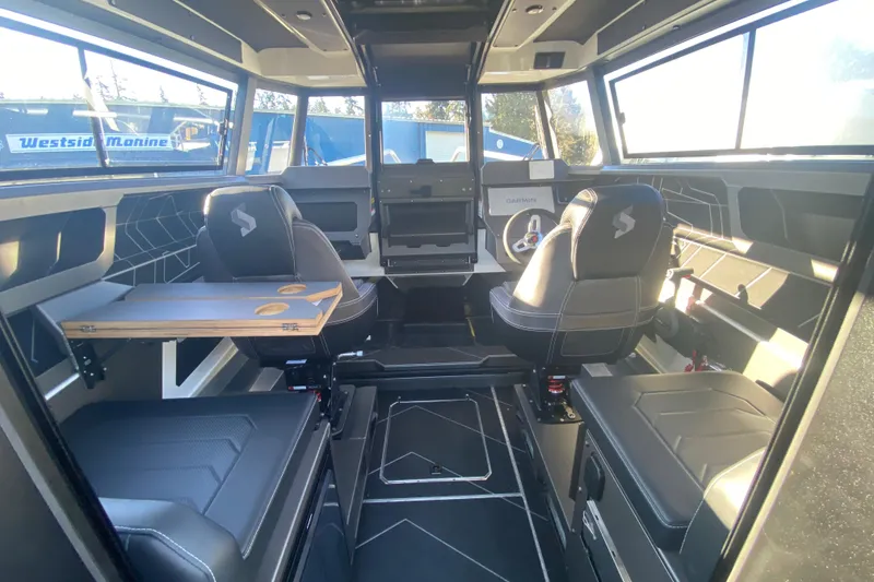 Slide: The Image of Interior of 2026 Stabicraft 2350 ULTRACAB WT SPORTFISH, featuring modern seating and navigation equipment. - 6