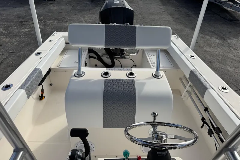 Slide: The Image of 2006 May-Craft 2000CC boat interior with steering wheel and seating. - 18