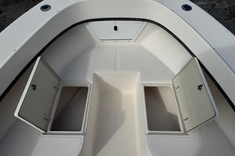 Slide: The Image of 2006 May-Craft 2000CC boat interior with open storage compartments. - 20