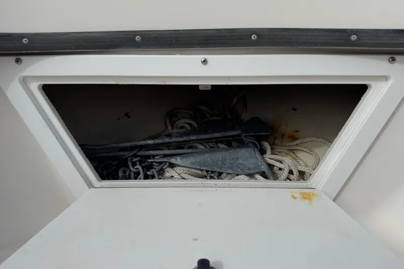 Slide: The Image of Storage compartment with ropes and anchors on a 2006 May-Craft 2000CC boat. - 21