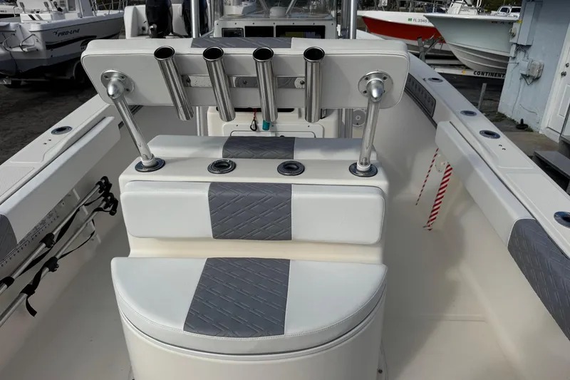 Slide: The Image of 2006 May-Craft 2000CC boat interior with rod holders and cushioned seating. - 23