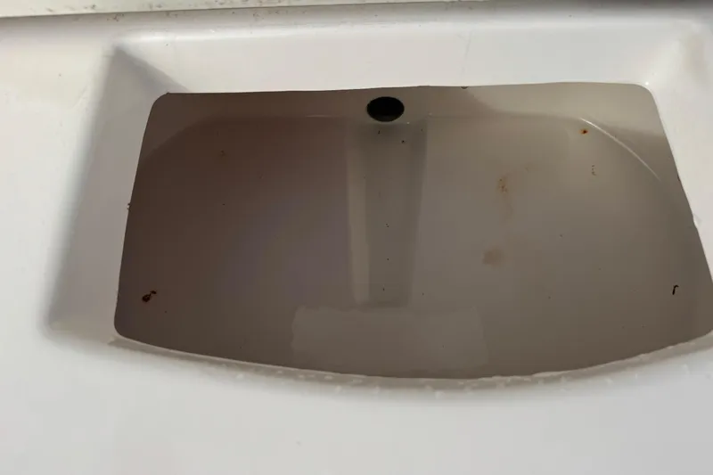 Slide: The Image of Dirty sink with standing water in a 2006 May-Craft 2000CC boat. - 24