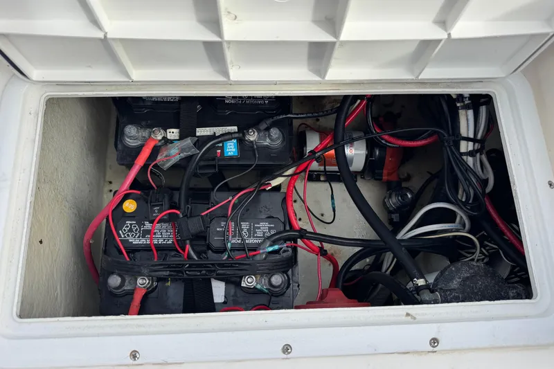 Slide: The Image of Battery compartment of a 2006 May-Craft 2000CC boat, showing wiring and connections. - 26