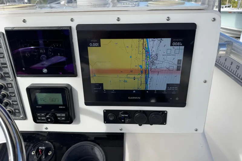 Slide: The Image of Boat dashboard with Garmin GPS and control panels on a 2006 May-Craft 2000CC. - 6