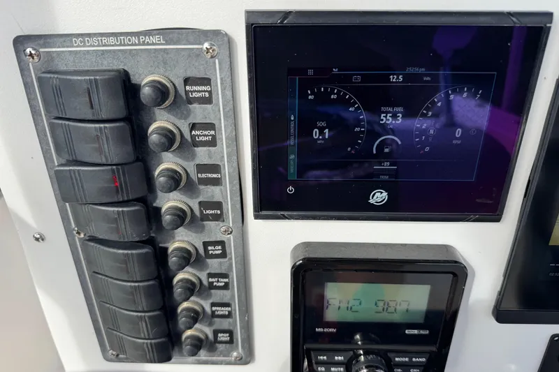 Slide: The Image of Control panel of a 2006 May-Craft 2000CC boat with digital display and switches. - 7
