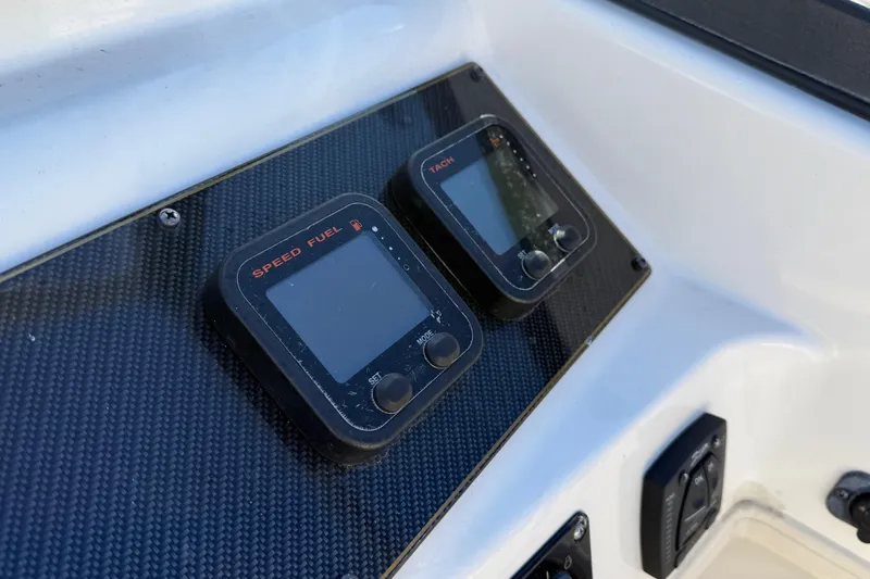 Slide: The Image of Dashboard of 2015 Grady-White Freedom 192 boat with speed and fuel gauges. - 5