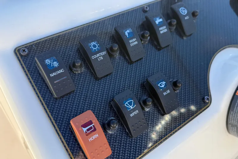 Slide: The Image of Control panel of a 2015 Grady-White Freedom 192 boat with labeled switches. - 6