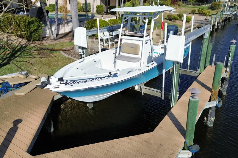 Slide: The Image of 2018 Sportsman Masters 247 Bay Boat on lift at dockside. - 16