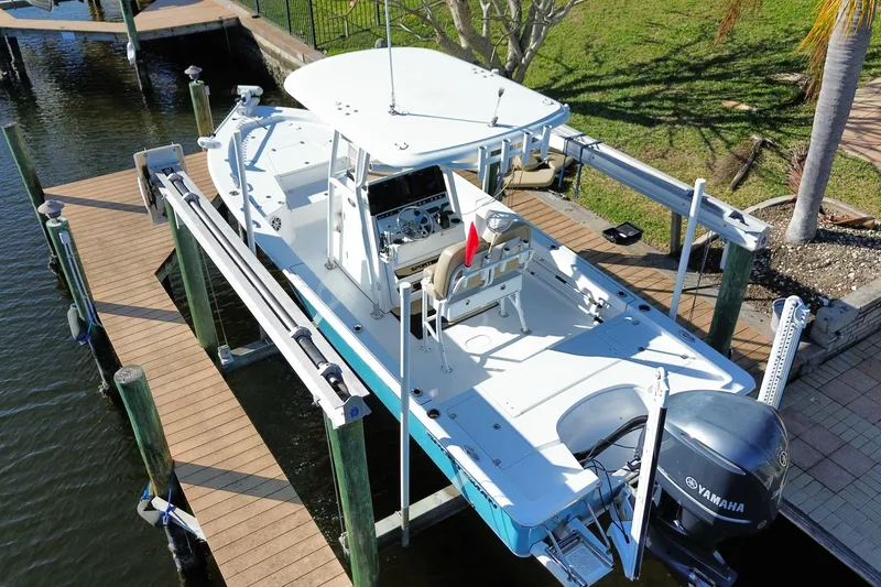 Slide: The Image of 2018 Sportsman Masters 247 Bay Boat docked, featuring Yamaha engine and spacious deck. - 18