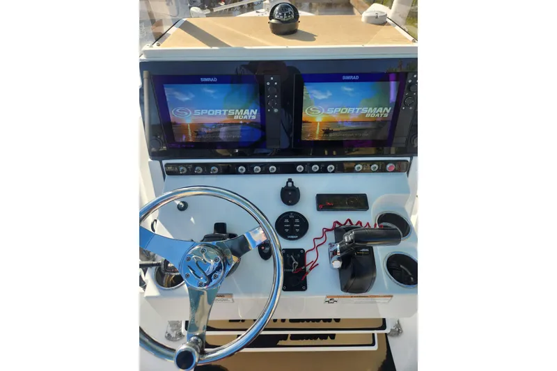 Slide: The Image of 2018 Sportsman Masters 247 Bay Boat dashboard with dual Simrad displays and steering wheel. - 4