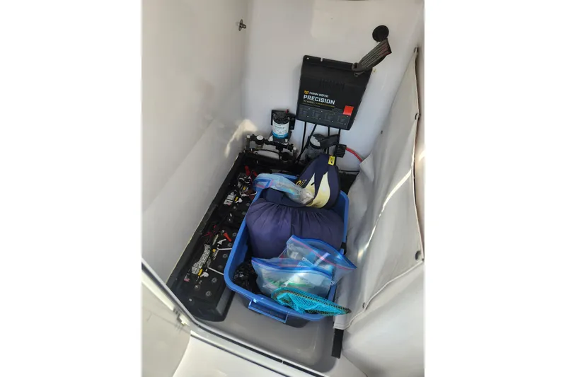 Slide: The Image of 2018 Sportsman Masters 247 Bay Boat storage compartment with battery and gear. - 6